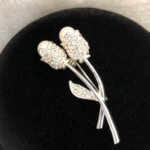 Silver Floral Brooch Embellished with simulated pearls and tiny diamonds.